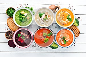 Variety of colorful vegetables cream soups. Concept of healthy eating or vegetarian food. Top view.