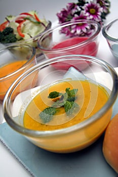Variety of colorful vegetables cream soups and ingredients for soup with bun