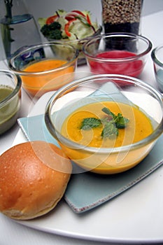 Variety of colorful vegetables cream soups and ingredients for soup with bun