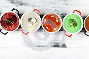 Variety of colorful vegetables cream soups and ingredients for soup. Concept of healthy eating or vegetarian food with mushrooms