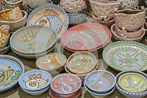 Variety of Colorfully Painted Ceramic Pots in an Outdoor Shopping Market. pottery in the shop window