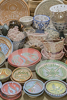 Variety of Colorfully Painted Ceramic Pots in an Outdoor Shopping Market. pottery in the shop window. vertical photo