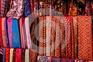 A variety of coloured cloths and silks from Asia