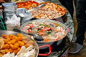 Variety of cooked Chinese food on display for takeaway at Camden Market