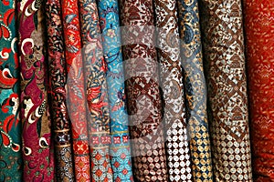 A variety of different bolts of brocade fabric