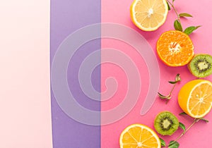 Variety of Different Tropical Seasonal Summer Fruits. Citrus Orange Pineapple Lemons Kiwi on Overlapping Paper in Trendy Pastel Co