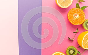 Variety of Different Tropical Seasonal Summer Fruits. Citrus Orange Pineapple Lemons Kiwi on Overlapping Paper in Trendy Pastel Co