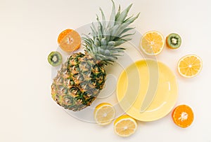 Variety of Different Tropical Seasonal Summer Fruits. Citrus Oranges Pineapple Lemons on White Background with pastel yellow trend