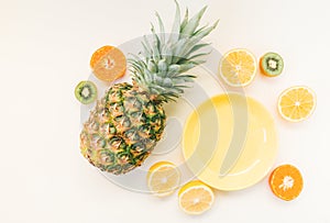 Variety of Different Tropical Seasonal Summer Fruits. Citrus Oranges Pineapple Lemons on White Background with pastel yellow trend