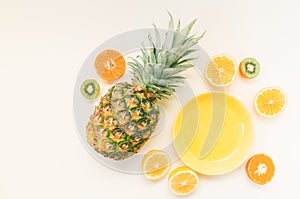 Variety of Different Tropical Seasonal Summer Fruits. Citrus Oranges Pineapple Lemons on White Background with pastel yellow trend