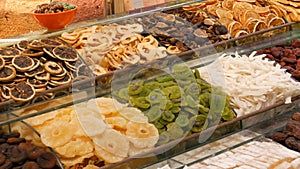 A variety of dried fruits on the counter of Turkish store. Dried oranges, lemons, kiwi, pineapple, apricots, dates