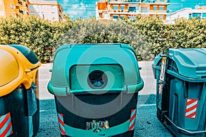 Variety dumpstersrecycling containers  on a city street