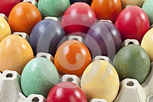 Variety of Easter eggs in egg carton, close up