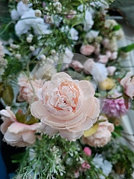 A variety of fake flowers are used to decorate the wedding reception room. lily, rose, tulip etc