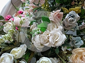 A variety of fake flowers are used to decorate the wedding reception room. lily, rose, tulip etc