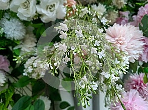 A variety of fake flowers are used to decorate the wedding reception room. lily, rose, tulip etc