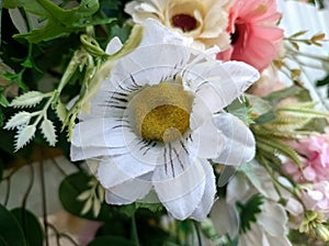 A variety of fake flowers are used to decorate the wedding reception room. lily, rose, tulip etc