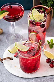 Variety of festive Christmas cocktails with cranberry and lime