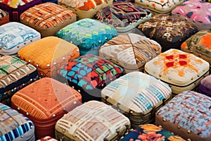a variety of finished footstools displayed in patterns