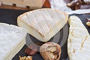 French soft cheeses - camembert, marcaire, munster, brie - delicious dessert with nuts and dried fruits