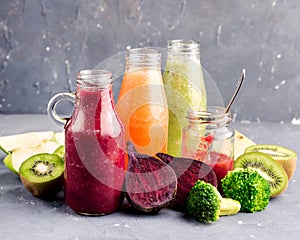 Variety of fresh vegetable and fruits moothie in glass bottles