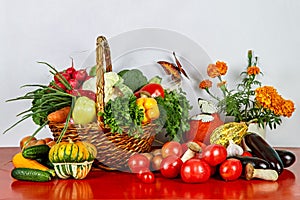 Egetables in a basket on a red table.