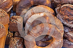 Variety of freshly baked rustic bread loaves on display on a market stall in the UK