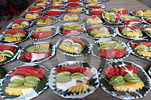 Variety of Fruit Catering in plastic wrap to serve on wooden table with reflect on plastic high constrast photo