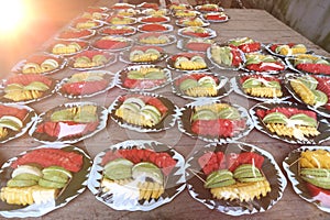 Variety of Fruit Catering in plastic ready to serve on wooden table with reflect on plastic high constrast photo