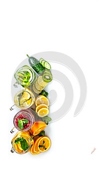 Variety of fruit infused detox water in jars for a healthy diet eating and weight loss. healthy lifestyle concept, overhead view