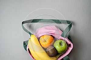 Variety of fruits grapefruit, kiwi, banana, orange from pink li
