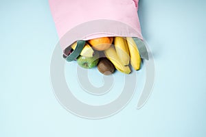 Variety of fruits grapefruit, kiwi, banana, orange from pink li