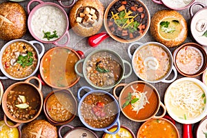 Variety of Garnished Soups in Colorful Bowls