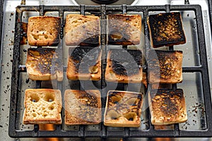 A variety of golden brown toasted sandwiches sit atop a stove, showcasing their deliciously crispy exteriors