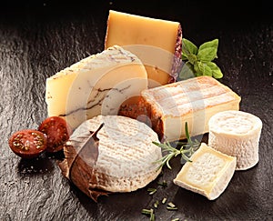 Variety of Gourmet Cheeses with Fresh Herbs