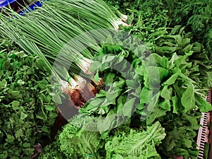 Variety of green vegetables in a supermarket. Consumption of green vegetables has increased in recent years, as more