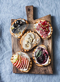 Variety grilled bread dessert sandwiches with cream cheese and apple, pomegranate, jam, grapes, peanut butter, banana, flax seed,