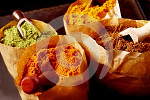 Variety of ground spices in paper bags