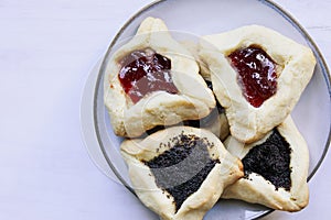 Variety of hamantaschen cookies filled with mohn paste and plum jam