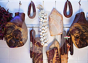 Variety of hungarian cured meat products and fresh peppers and o