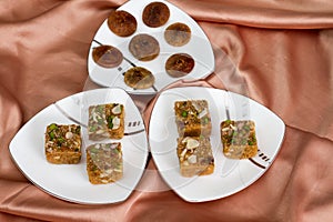 Variety of Indian sweets serves in plates