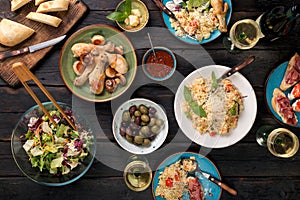 Variety of Italian food with wine on dark wooden table