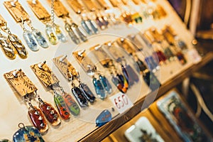 Variety of jewelry in store. Rings, bracelets, earrings and necklaces on stands for sale.