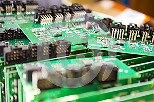 Variety of Just Produced Automotive Printed Circuit Boards with Surface Mounted Components with PCBs On Top of Boards. Shallow DOF