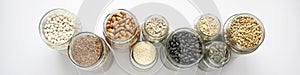 Variety of legumes and seeds in glass jars. Zero waste storage, no plastic concept