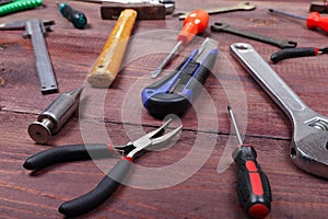 Variety of locksmith tools for repair work on wooden background