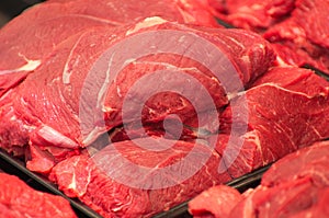 Variety of meat slices in boxes in supermarket