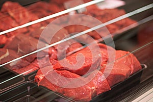 Variety of meat slices in boxes in supermarket