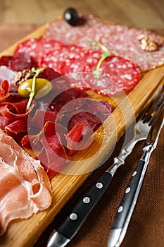 Variety of meats, sausages, salami, ham, olives