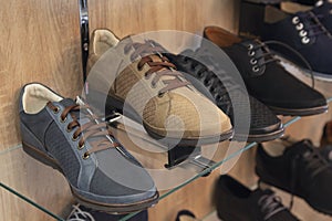 Variety of men`s shoes in the shop window